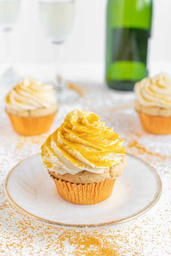 Photo of the plated finished Champagne Cupcakes recipe topped with the gold sprinkles for New Year's Eve or Mother's Day