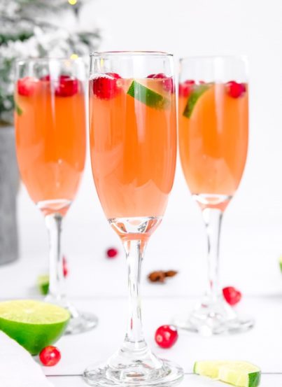 This is a super festive Holiday Mimosas recipe for whether you're hosting a holiday brunch or an elegant holiday party that will brighten everyone's day!