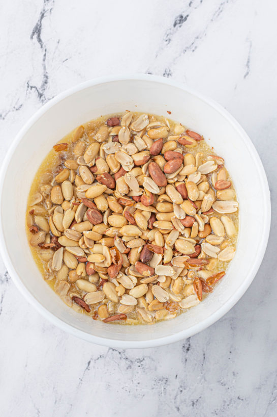 Adding the roasted peanuts needed to make the Microwave Peanut Brittle recipe