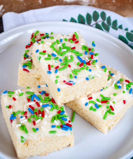 The Holiday Sugar Cookie Bars all cut up and on a plate for serving