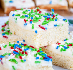 This Holiday Sugar Cookie Bars recipe is the easiest way to make sugar cookies! They are SO delicious topped off with a sweet, creamy frosting!