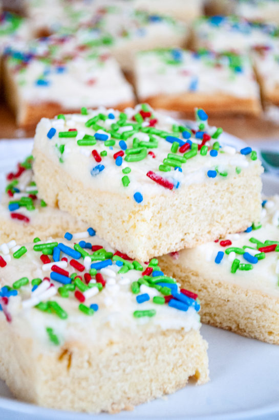 This Holiday Sugar Cookie Bars recipe is the easiest way to make sugar cookies! They are SO delicious topped off with a sweet, creamy frosting!