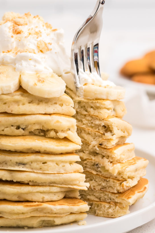 Cutting open the Banana Pudding Pancakes that are flavorful enough you don't even need the syrup! They are a quick and easy breakfast or brunch recipe you will love!