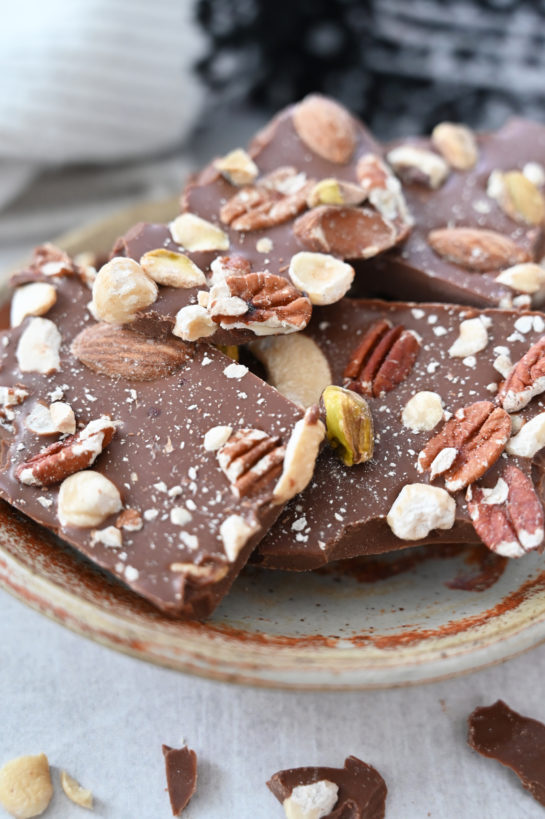 Close up, plated 5-ingredient Salted Chocolate Almond Hazelnut Bark recipe is a beautiful, festive special occasion or holiday dessert that makes for a great edible birthday or Christmas gift for family, co-workers, and friends!