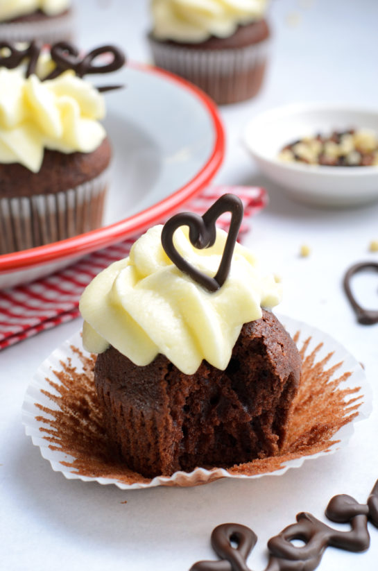 Valentine's Day Lover's Chocolate Cupcakes recipe with a bite taken out of them to show the inside of the cupcakes