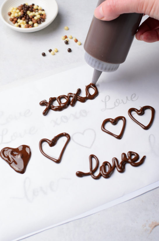 Writing out words in chocolate for the Valentine's Day Lover's Chocolate Cupcakes recipe