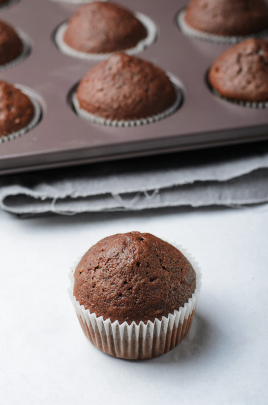 Taking the cupcakes out of the oven for the Lover's Chocolate Cupcakes recipe