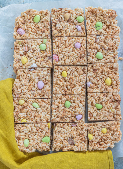 Photo of the cut-up Mini Egg Rice Krispie Treats that are a deliciously addictive dessert recipe for Easter! They’re super easy and fun to make with kids. The perfect Easter sweet treat!