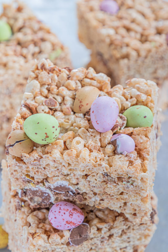 Close-up shot of the cut-up Mini Egg Rice Krispie Treats that are a deliciously addictive dessert recipe for Easter! They’re super easy and fun to make with kids. The perfect Easter sweet treat!