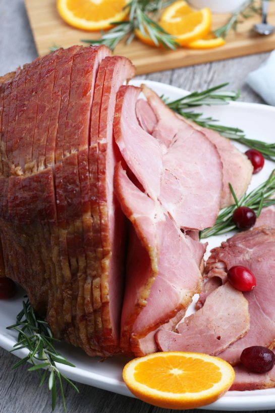 Close-up shot of the plated Glazed Spiral Ham recipe with a sweet glaze uses a fully-cooked ham and is a great centerpiece for your Christmas, Easter, or Thanksgiving dinner table! The flavor and texture will be a show-stopper!