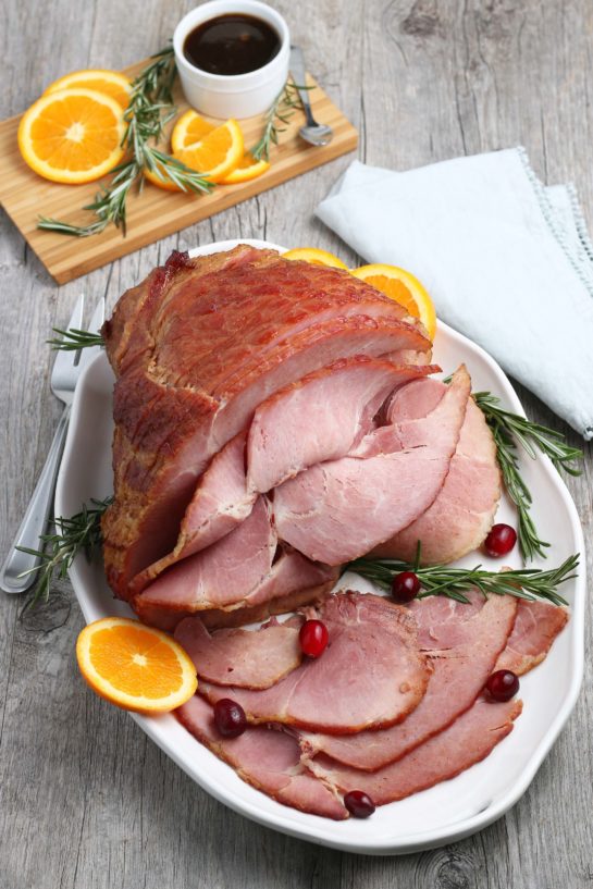 Overhead shot of Glazed Spiral Ham recipe with a sweet glaze uses a fully-cooked ham and is a great centerpiece for your Christmas, Easter, or Thanksgiving dinner table! The flavor and texture will be a show-stopper!