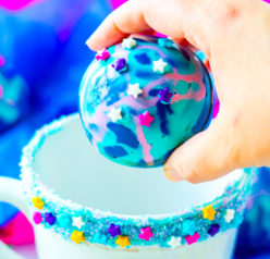 Galaxy Hot Chocolate Bombs are fun, colorful chocolate orbs filled with hot cocoa mix, marshmallows, and sprinkles. This recipe for hot chocolate bombs is an over-the-top way to level up your hot chocolate game, especially for a party!