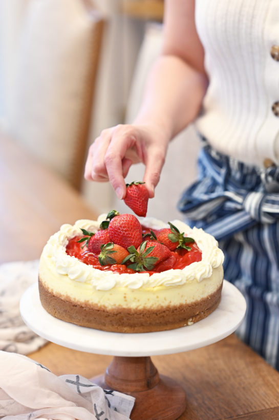 Topping the Strawberry Topped New York-Style Cheesecake recipe with the strawberries