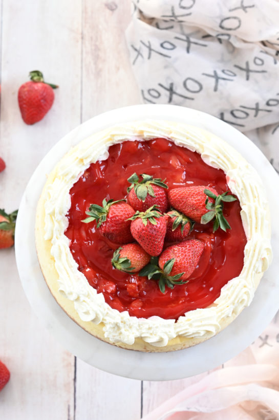 Overhead shot of Strawberry Topped New York-Style Cheesecake recipe is the perfect combination of tangy cheesecake and sweet summer berries! It also looks beautiful on your table!