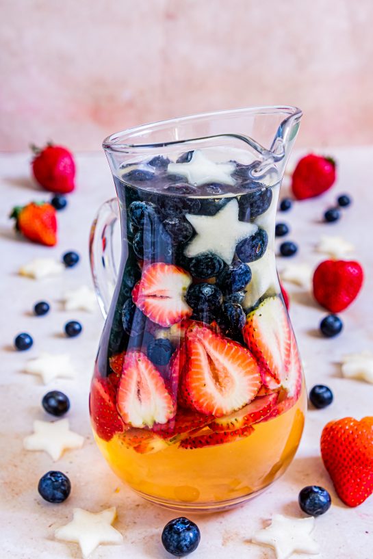 Sip on my Patriotic Sangria recipe this summer to enjoy a cocktail while beating the heat at the same time! With fresh blueberries, strawberries, white grape juice, brandy, and wine, it's perfect for 4th of July or Memorial Day!
