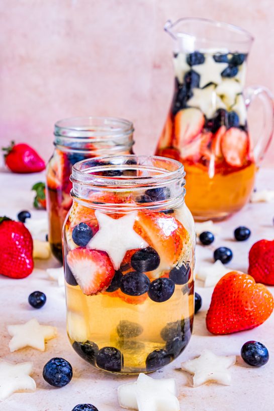Sip on my Patriotic Sangria recipe this summer to enjoy a cocktail while beating the heat at the same time! With fresh blueberries, strawberries, white grape juice, brandy, and wine, it's perfect for Flag Day, 4th of July or Memorial Day!