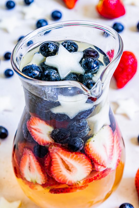 Drink on my Patriotic Sangria recipe this summer to enjoy a cocktail while beating the heat at the same time! With fresh blueberries, strawberries, white grape juice, brandy, and wine, it's perfect for 4th of July or Memorial Day!