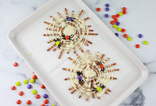 Halloween Chocolate Pretzel Spider Webs are fun sweet & salty dessert recipe to serve for a children's or adult Halloween party! They are easy to make and look so cute on your party table!