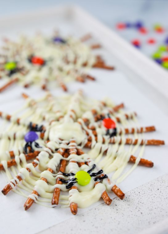 Halloween Chocolate Pretzel Spider Webs are a fun sweet & salty dessert recipe to serve for a children's or adult Halloween party! They are easy to make and look great on your party table!
