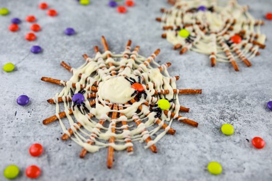 Halloween Chocolate Pretzel Spider Webs are fun sweet & salty dessert recipe to serve for a children's or adult Halloween party! They are easy to make and look great on your party table!