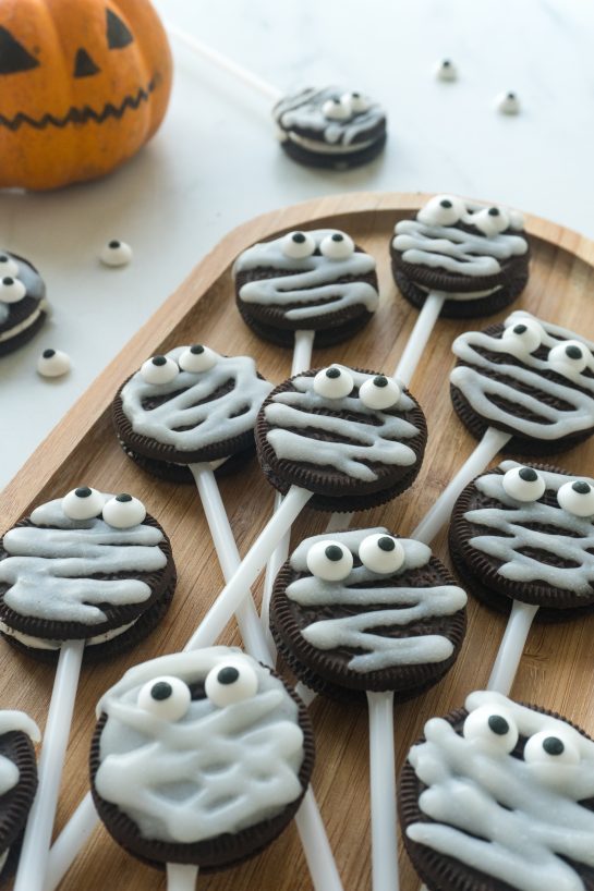 These Halloween Mummy Oreo Pops are an adorable recipe and so easy to make! With just a few ingredients and a fun time decorating, you will have these super cute treats that kids will love!