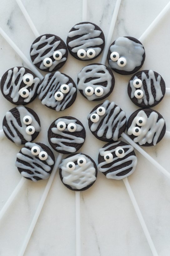 These Halloween Mummy Oreo Pops are an adorable recipe and so easy to make! With just a few ingredients and a fun time decorating, you will have these super cute treats that kids and adults will love!