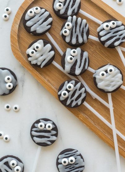 These Halloween Mummy Oreo Pops are adorable and so easy to make! With just a few ingredients and a fun time decorating, you will have these super cute treats that kids will love!