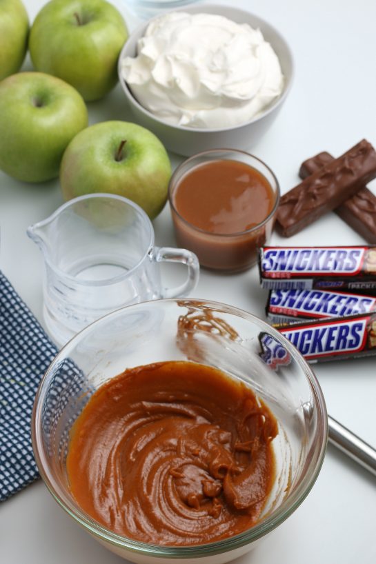 Mixing the caramel sauce for the Caramel Apple Snickers Salad