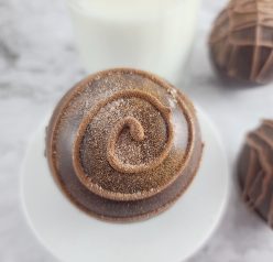 Close-up photo of the finished Mocha Hot Chocolate Bombs with coffee flavor are all the rage this holiday season! Make this recipe ahead of time as an edible holiday gift, fulfill a chocolate craving, or a holiday dessert tray addition.