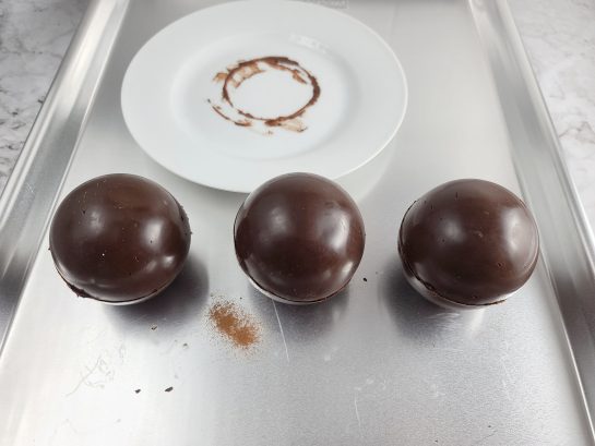 Putting the half spheres together to make the Mocha Hot Chocolate Bombs recipe 