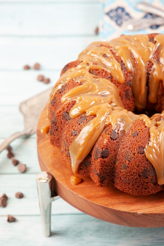 Ganache-covered Peanut Butter Chocolate Chip Bundt Cake recipe is super easy and delicious cake that always pleases! The cake always comes out moist and is the perfect cake!