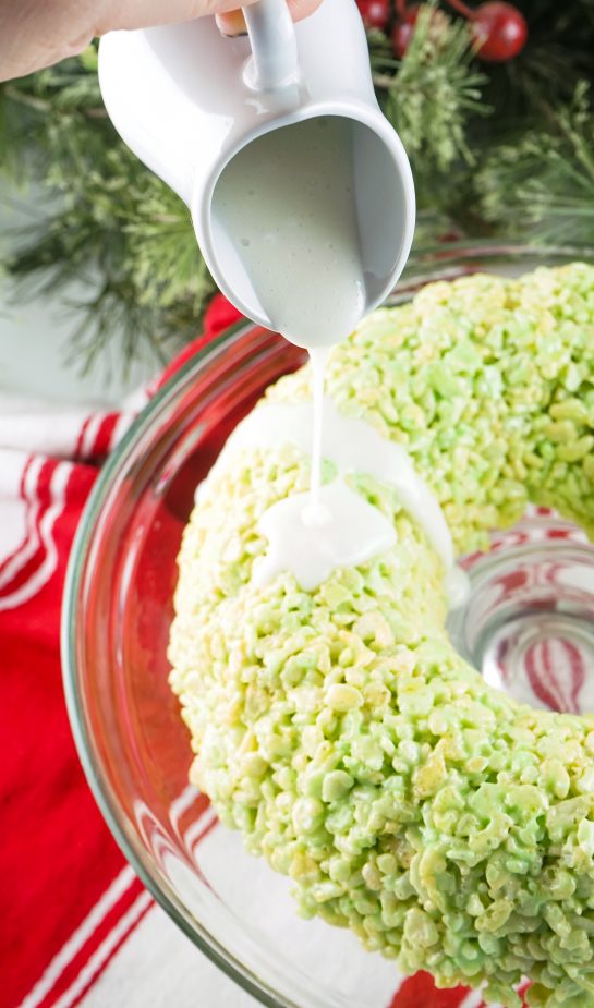 Drizzling the glaze on the Rice Krispies Treats Wreath Cake recipe