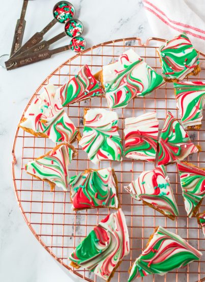 Christmas Ritz Cracker Candy recipe is a quick stovetop toffee poured over buttery Ritz crackers, coated in chocolate and topped with sprinkles. Once cooled, it is cracked into chunks and ready to be devoured!
