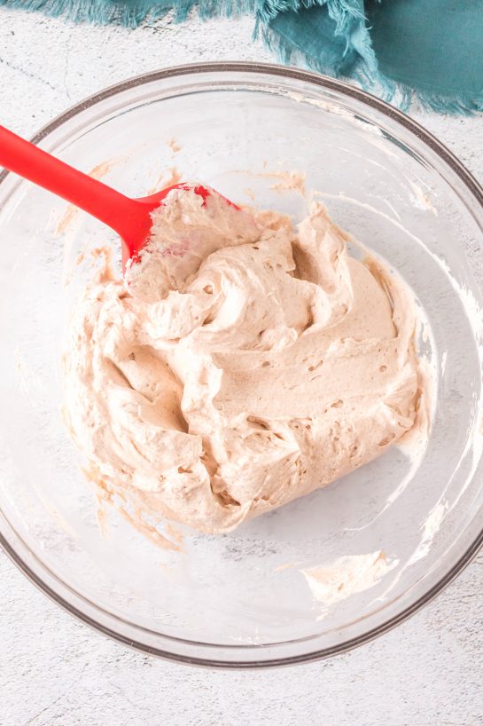 Cream cheese being mixed to make this easy Cinnamon Roll Dip recipe