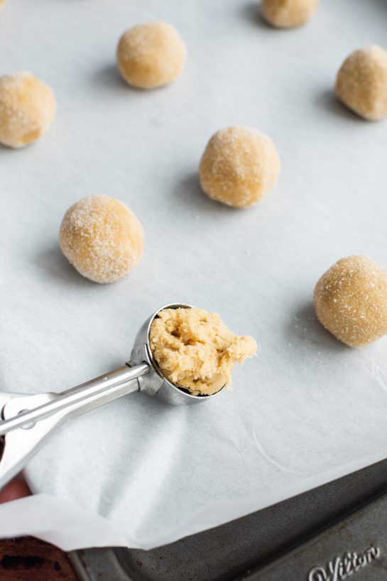 Scooping the dough for the Peanut Butter Thumbprint Cookies recipe 