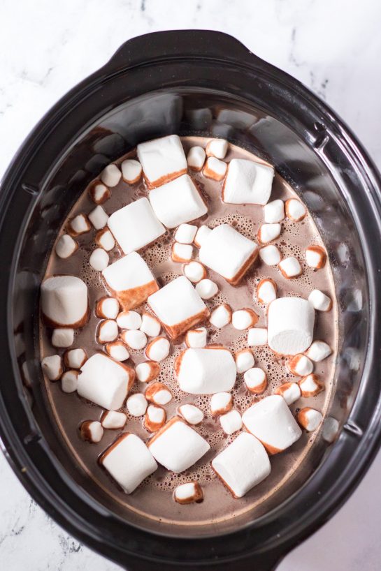 Adding the marshmallows for the Crock Pot Caramel Hot Chocolate recipe