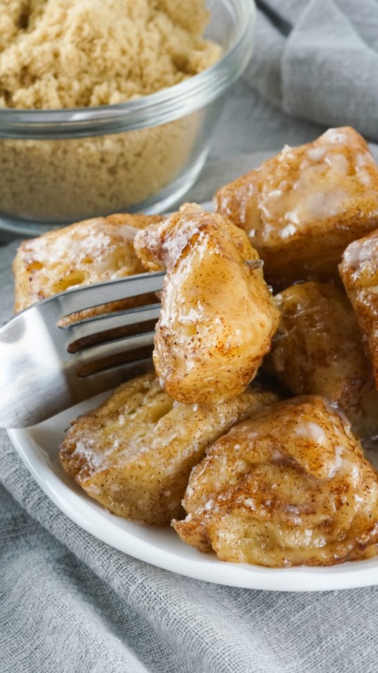 Crock Pot Monkey Bread turns your classic monkey bread recipe into a delicious slow cooker creation. Full of delicious biscuits, coated in cinnamon and sugar, then drizzled with a rich icing. Perfect for breakfast or dessert.