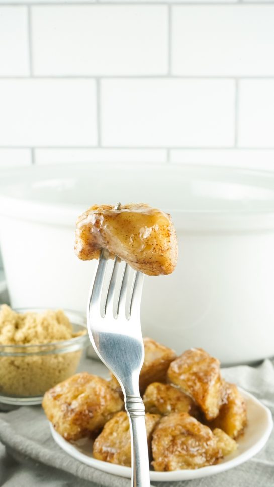 Crock Pot Monkey Bread turns your classic monkey bread recipe into a delicious slow cooker meal for holidays. Full of delicious biscuits, coated in cinnamon and sugar, then drizzled with a rich icing. Perfect for brunch, breakfast or dessert.