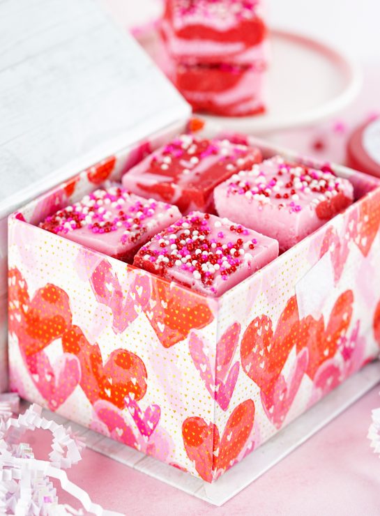 Easy Layered Valentine's Day Strawberry Fudge recipe uses just 4 easy ingredients and can be made in under 10 minutes! Pretty and cute gift for your favorite Valentine.