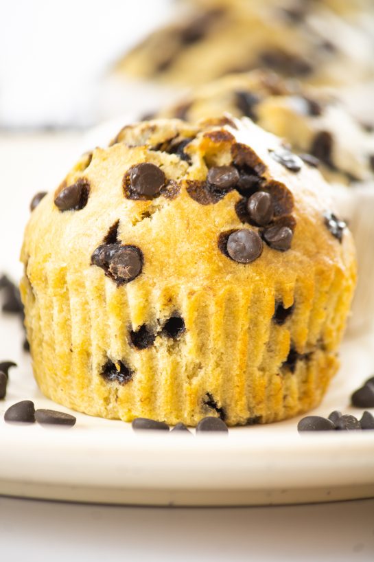 Close-up photo of the quick and easy Banana Chocolate Chip Muffins recipe loaded with chocolate chips and fresh bananas. This warm treat can be enjoyed by your family on any given day and only requires a few easy ingredients.