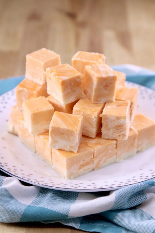 Creamsicle Fudge Recipe is one of our favorite treats for the holidays. A nostalgic flavor that everyone loves and makes a fantastic homemade gift for any occasion.