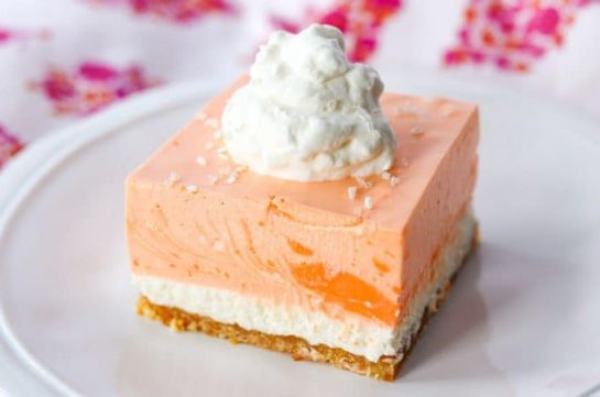 Totally a dream, these easy no bake Orange Creamsicle Dream Bars Recipe will take you right back to your childhood. A cookie crust, vanilla cheesecake and a creamy orange cream topping will be a dessert the whole family will enjoy.