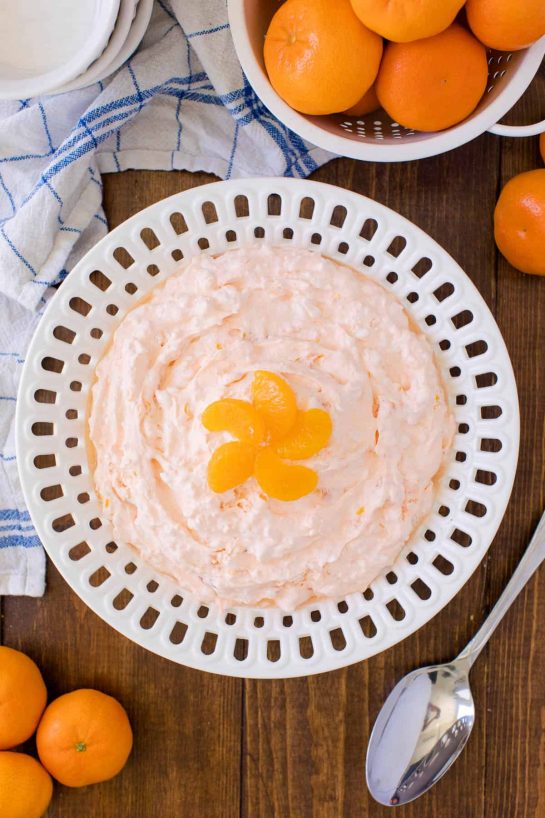 The fluffiest Orange Creamsicle Salad recipe dessert! You'll dream about your childhood ice cream cravings with this creamy fruit salad with cottage cheese, Jello, and mandarin oranges.