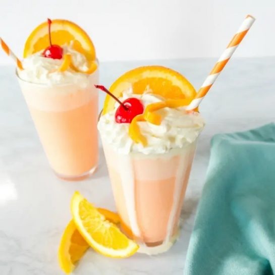 This Orange Creamsicle Milkshake Recipe tastes just like those Creamsicles you always loved as a kid! Made with just three ingredients, it’s an easy dessert that everyone will love!