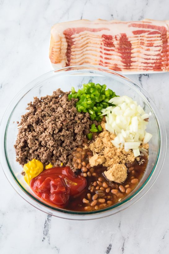 Mixing the ingredients needed to make the beefy baked beans side dish recipe