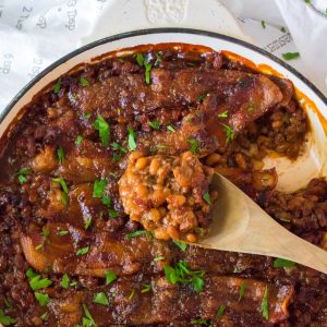 Beefy Baked Beans are my favorite!! Beans get mixed with ground beef, onion and bell pepper, brown sugar, ketchup, mustard and Worcestershire before getting topped with a peppered brown sugar bacon.