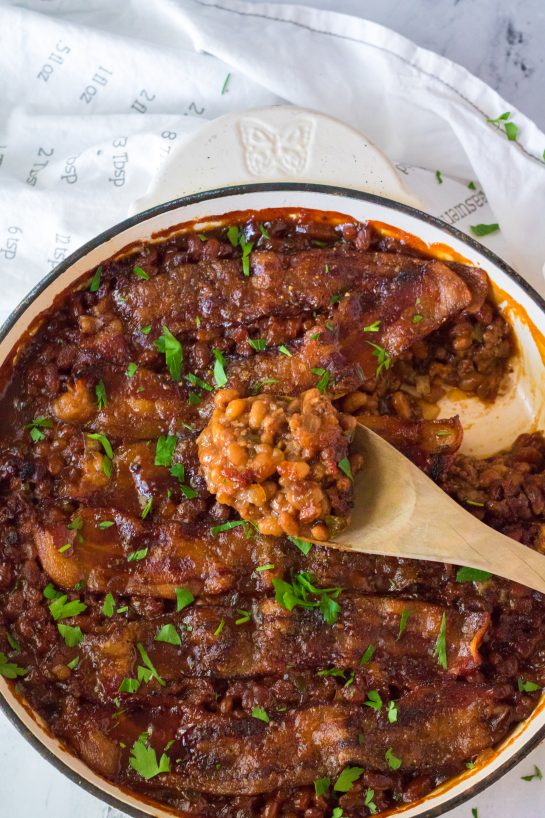 Beefy Baked Beans are my favorite!! Beans get mixed with ground beef, onion and bell pepper, brown sugar, ketchup, mustard and Worcestershire before getting topped with a peppered brown sugar bacon.