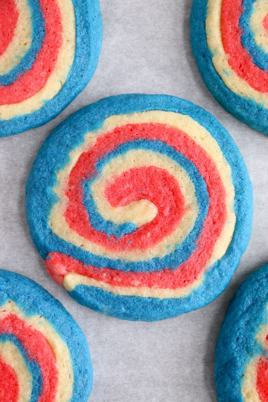 Easy Patriotic Pinwheel Cookies are a classic, slice and bake soft sugar cookie recipe all jazzed up for the 4th of July! These patriotic pinwheel cookies have beautiful swirls of red, white and blue. 