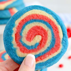 Patriotic Pinwheel Cookies are a classic, slice and bake soft sugar cookie recipe all dressed up for the 4th of July 4! These patriotic pinwheel cookies have beautiful swirls of red, white and blue. 