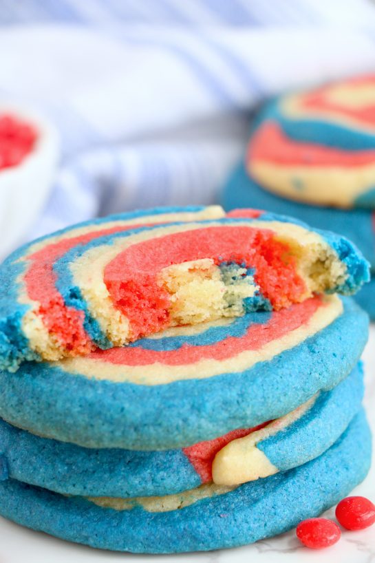 Patriotic Pinwheel Cookies are a classic, slice and bake soft sugar cookie recipe all decked out for the 4th of July! These patriotic pinwheel cookies have beautiful swirls of red, white and blue. 